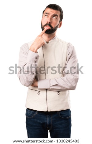 Handsome man with vest having doubts on isolated white background
