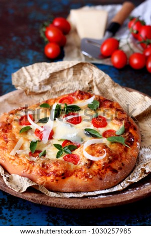 Pizza with mozzarella and basil leaves  
