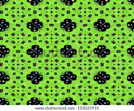 Quilted blanket has large black butterfly decorated with colorful and fun polka dots. Green fabric also has random polka dots in black and white.
