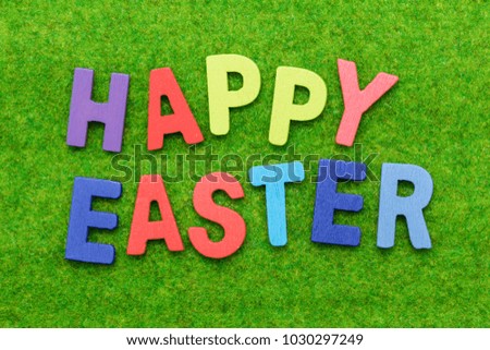 background of  Happy Easter wooden alphabet on a green grass