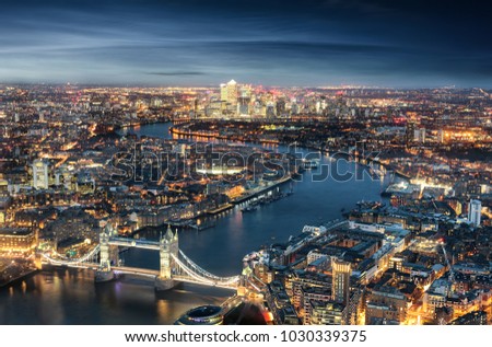Aerial view of London: from the Tower Bridge to the financial district Canary Wharf during evening time
