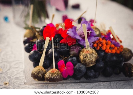 Chocolate candies on the plate decorated with flowers
