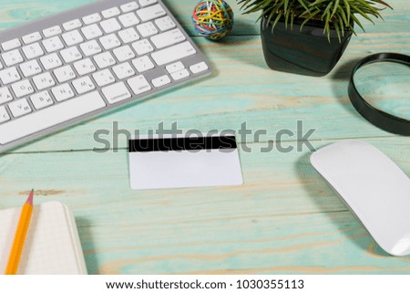 Top view office table. notebook and computer and blank credit card on wood background.