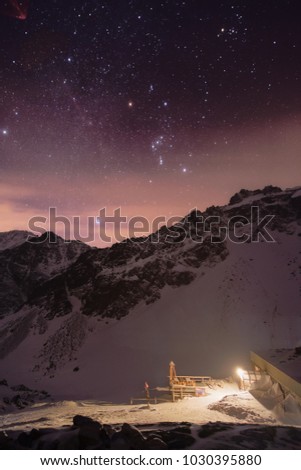 High altitude mountain hut in winter in the night under the stars in High Tatras national park, Slovakia