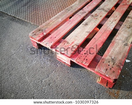 Colourful red europallet on a sunny day in front of a storehouse in Oerlinghausen in East Westphalia-Lippe, Germany