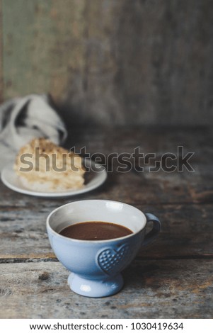 cup of hot coffee and a piece of cake in the background. copy space