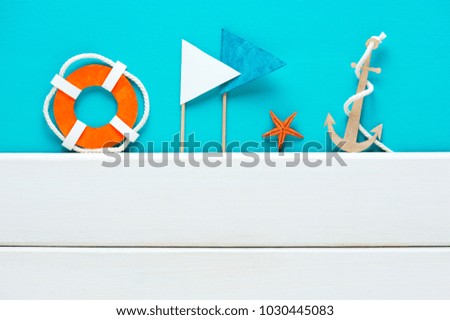 Blue background with handmade paper elements of marine decoration and white boards, copy space