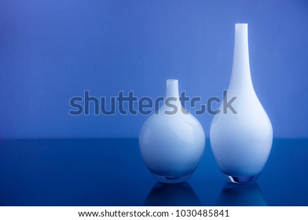 two white vases and background with two shades of blue