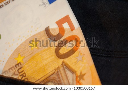 50 euro banknote in the back pocket of the trousers