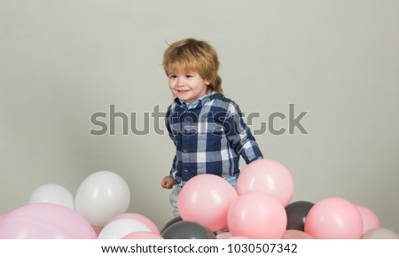Little boy laughs and has fun, joy funny kid. Cute smile from young model. Decorations for children's photo session. Clothes for the youngest. Kid model wears clothes for advertising