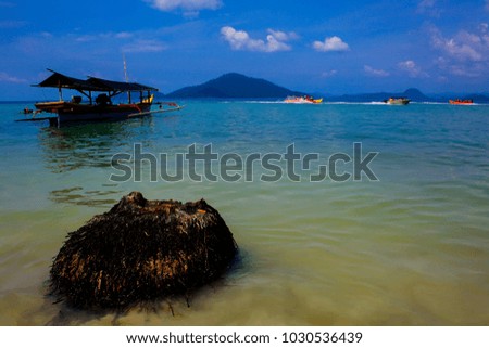 tropical beach with boat and blue sky