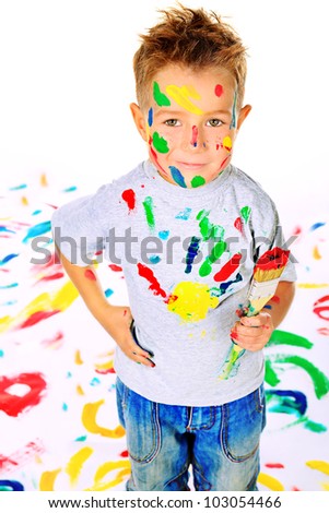 Portrait of a little boy enjoying his painting. Education.