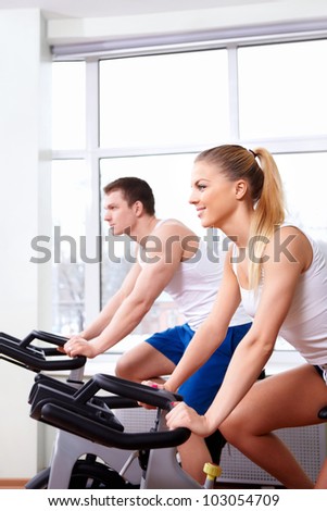 Young people on bikes indoors