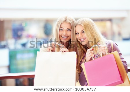 Beautiful girls with shopping bags in store