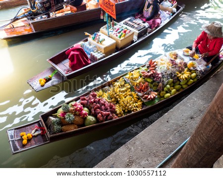 Damnoen saduak floating market.Thai market-red, yellow fruits. 