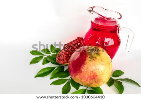 Pomegranate juice with fresh pomegranate on white background.
Healthy concept.