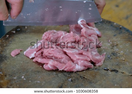 Women sliced pork on a board
