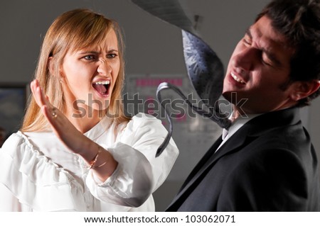 angry businesswoman is slapping across the businessman's face Royalty-Free Stock Photo #103062071