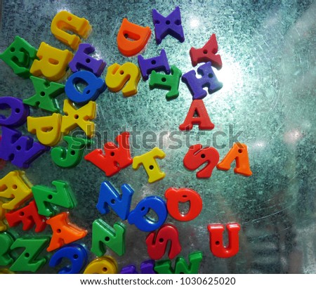 colorful plastic English alphabet magnetic letters metal background