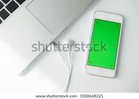 Modern White office desk table with blank screen smart phone, laptop computer. Top view with copy space.Working desk table concept.