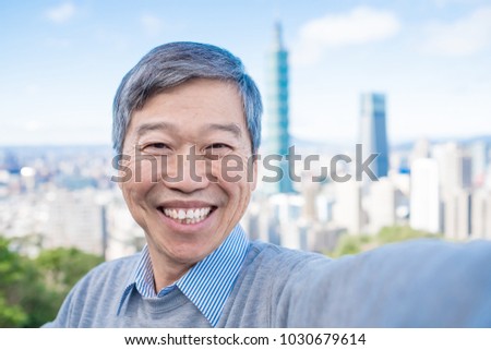 old man selfie happily in the moutain