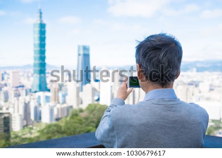 old man take picture on the moutain