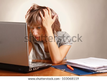 Exhausted female at her desk. Isolated