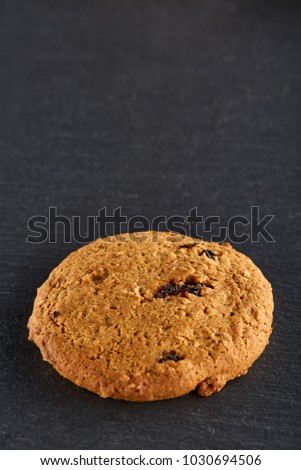 Lowkey picture of two chocolate cookies on dark background, close-up, shallow depth of field