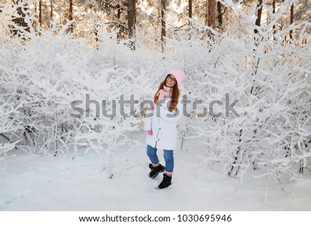 girl in winter forest with snow-covered branches of trees. fairy beauty