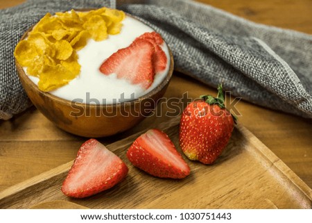Breakfast, Yogurt with strawberry on wooden background with copy space.