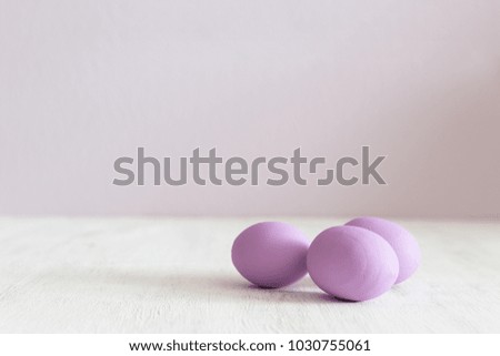 Easter postcard. Violet Easter eggs on a white vintage background. Copy space.