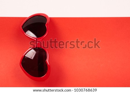 sunglasses on a red background, free space, beauty                               