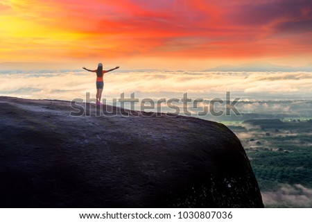 Woman Opens Her Arm, Enjoy the Fresh Air and Embrace the Natureon the three whale rock mountain at Phu Sing , Bueng Kan Province,Thailand
 Royalty-Free Stock Photo #1030807036
