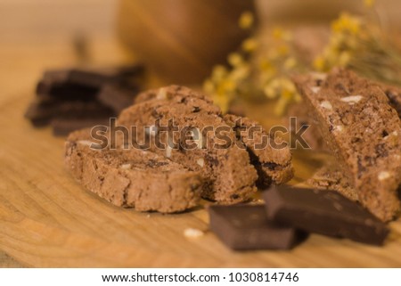 bread with candied fruit, chocolate and nuts close up picture, wooden table background
