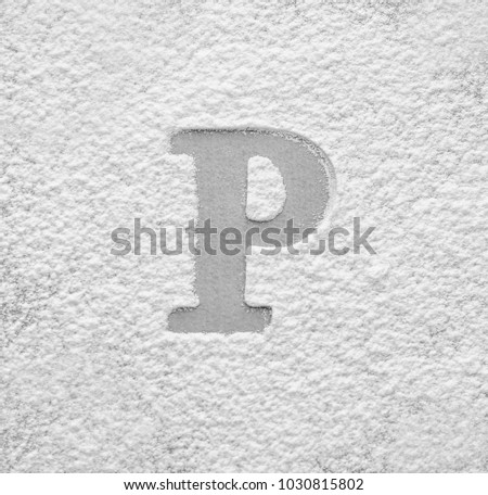 Silhouette of letter P on scattered flour