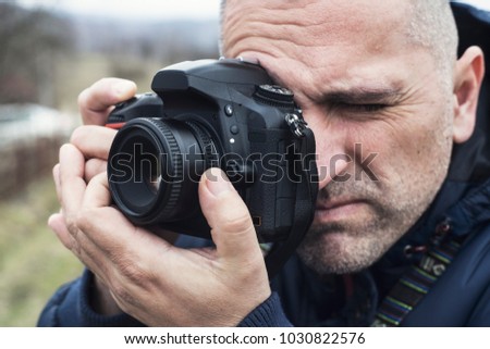 Photographer shooting outdoors scenery, close up