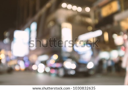 abstract blur and defocused modern car on the street at night in Hong Kong for background, old film look effect