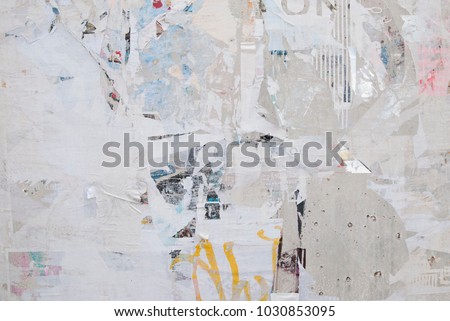 urban weathered exposed concrete wall with ripped torn street poster