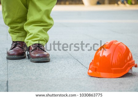 A man walking in to orange hat. Engineer man walking for work.He move left foot.It is symbol for good work.Photo engineer and work.