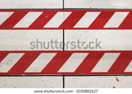 Red stripes lines marking safety zone on the floor