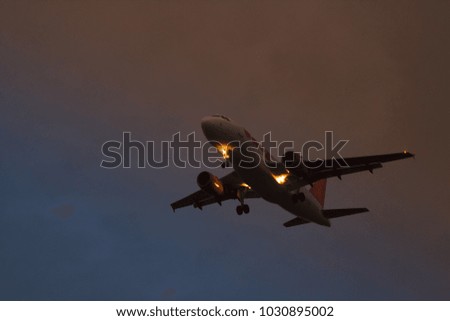 A plane taking off on the background of red yellow and blue sky