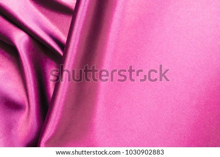 Smooth elegant wavy magenta pink silk or satin luxury cloth fabric texture, abstract background design.
Free space for text on the right side.