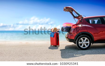 Summer time and red car on beach with few suitcase. Free space for your text or product. 