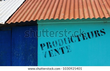 Closeup of sign - "Sales Producers" ("Producteurs Vente" in French) on a sailors hut