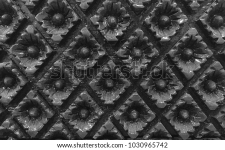 sculptured wood flower pattern on back & white background