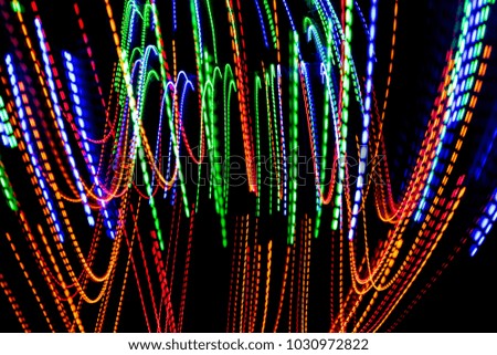 The beautiful lighting of path when there is movement of the origin of multi colored lights. Slow shooting style and light color blur Applied as a backdrop
