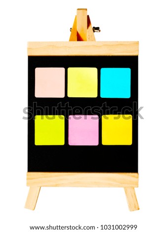 Blank colorful sticky notes on a black board on a stand, white background with clipping path, isolated