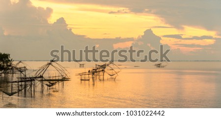 Landscape lake view with sunrise and sky background in the morning and traditional local fisherman use net fishing at Pakpra Thale Noi village landmark in Phatthalung Thailand