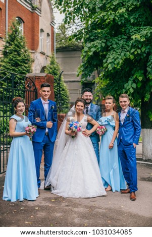 beautiful newlyweds with their friends having fun together. Friendship picture. Bridesmaids and groomsmen with bride and groom. Drinking champagne.