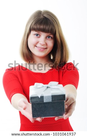 Young girl in red dress with gift box